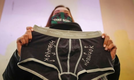 An activist holds underwear with writing saying ‘novichok’ at a rally in St Petersburg supporting Alexei Navalny.
