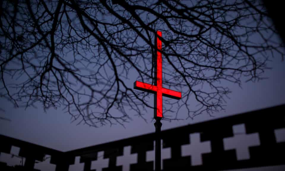 One of the neon red inverted crucifixes on Hobart’s waterfront as part of Mona’s midwinter music and arts festival, Dark Mofo.