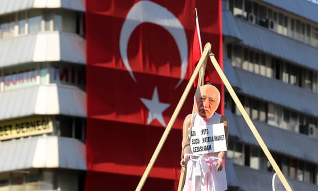 A picture taken on August 2, 2016 shows  a picture of US-based preacher Fethullah Gulen set up on a dummy at the Kizilay Square in front of a Turkish national flag  in Ankara during a protest against the failed military coup, on August 2, 2016. 
Erdogan said on August 2, 2016 last month's attempted coup was a scenario drawn up from outside Turkey, in an allusion to possible foreign involvement in the plot. Erdogan, who blames the plot on the US-based preacher Fethullah Gulen, also described the coup as a "scenario written from outside" in an allusion to foreign involvement.  / AFP PHOTO / ADEM ALTANADEM ALTAN/AFP/Getty Images