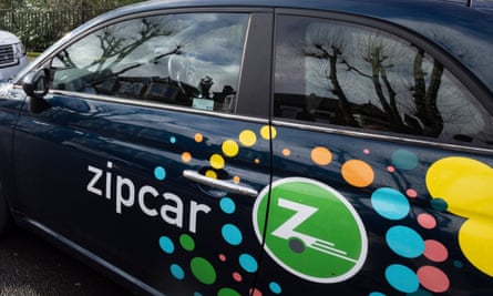 Closeup of Zipcar logo and branding on side of black Fiat 500