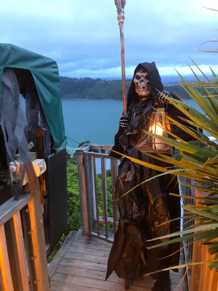 A person dressed as the Grim Reaper standing next to the funicular at Jess Hunt’s Halloween party.