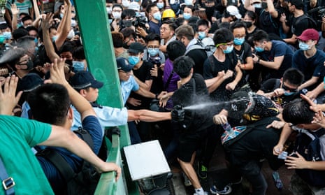 Anti-extradition bill protesters are sprayed with pepper spray by police in Hong Kong on 13 July.
