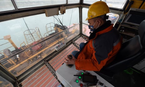 A crane operator at work at the international container terminal of Hefei port in east China’s Anhui province. 