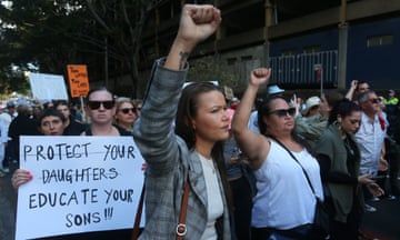 Women with fists in air or holding signs