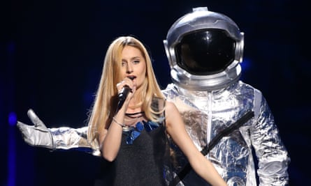 Lidia Isac is menaced by a man in a spacesuit during the Eurovision Song Contest