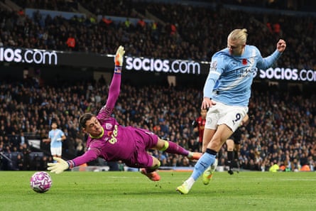 Erling Haaland of Manchester City scores past Djordje Petrovic.