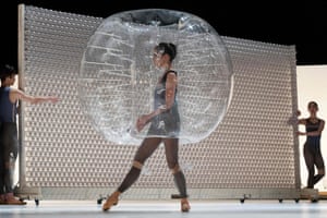 Dancer wearing inflated plastic ball around head and body