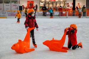 Children wearing look masks skate astatine an crystal rink successful Beijing, China