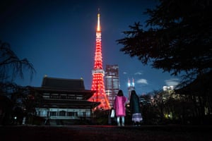 People visit Zojoji temple as Tokyo Tower is lit in red to celebrate the Lunar New Year