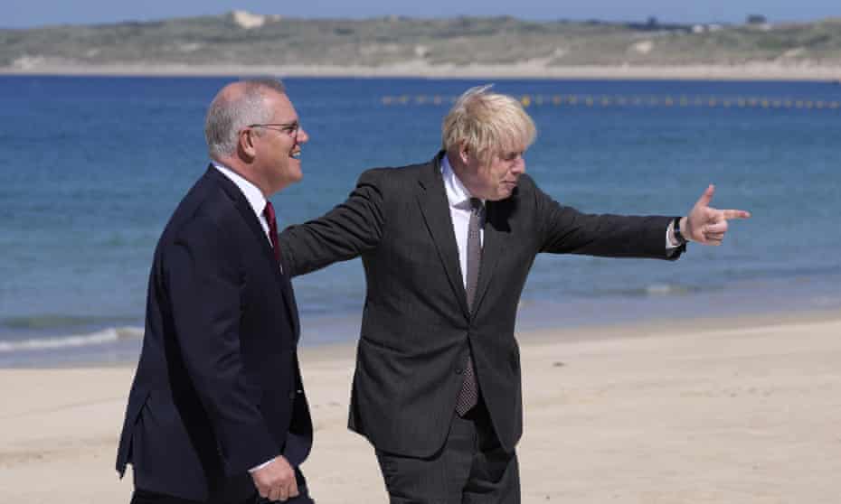 British Prime Minister Boris Johnson, right, greets Australia’s Prime Minister Scott Morrison