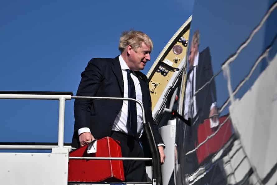 Boris Johnson boarding a plane at Stansted airport for his visit to India.