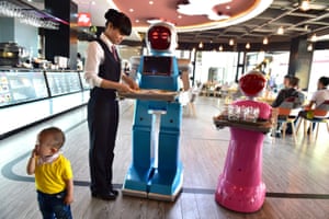 Novelty value … a couple of AI waiters, Little Blue and Little Peach, at a robot-themed restaurant in Yiwu.
