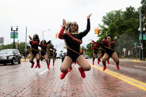 Dance captain Shair’Mae Harris, 17, leads members from “For The Love of Dance Studio” during a parade to celebrate Juneteenth in Flint, Michigan