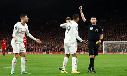 Michael Oliver shows Diogo Dalot the red card.