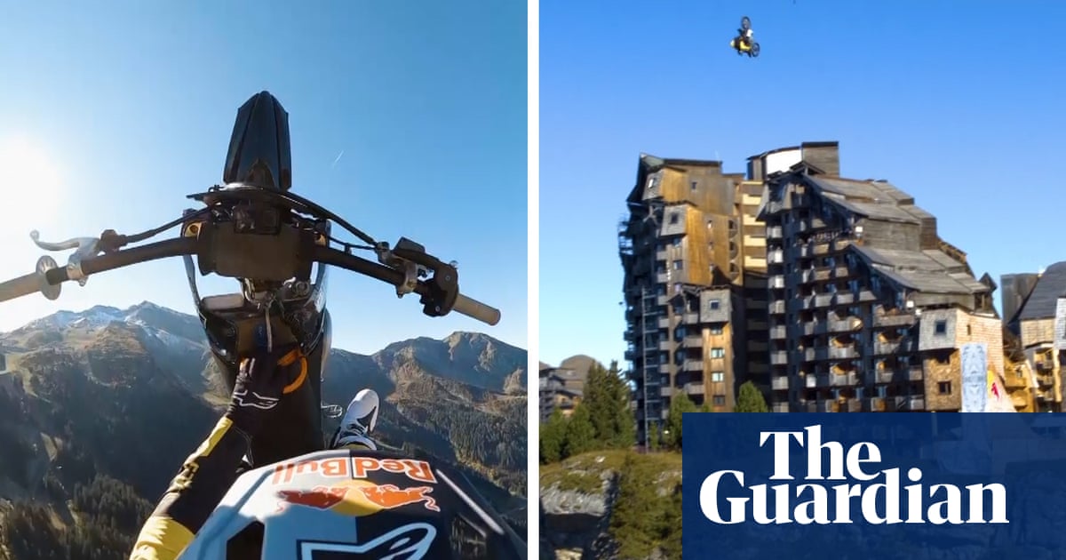 Motocross ace Tom Pages performs double front flip off cliff before parachuting down – video