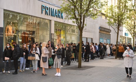 Customers queuing to enter a re-opened Primark clothes shop in Liverpool, north west England, on Monday April 12 as lockdown measures eased.