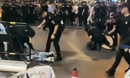 A screenshot from social media footage of the protests shows people being dragged away by police.