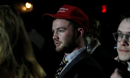 A man in a “Make America Great Again” hat listens to speakers at the Night for Freedom” party in Manhattan, New York.