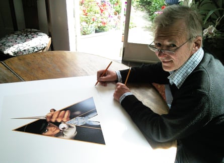Philip Castle signing the film poster for A Clockwork Orange, which is on a table in front of him