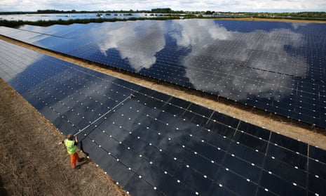 A workman cleans panels at Landmead solar farm near Abingdon, England. 