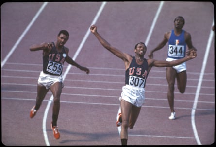 Smith, setting a world record time of 19.83 sec to win the 200m race; Carlos is to his left.