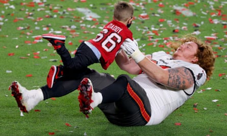 Ryan Jensen celebrates victory with his child after the Bucs’ title win