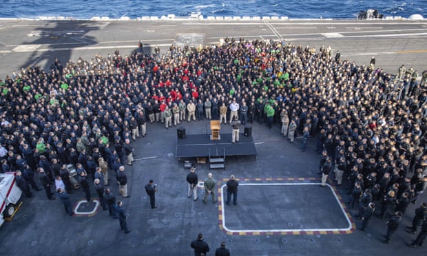 Capt Brett Crozier addresses the crew on the USS Theodore Roosevelt’s flight deck in December.