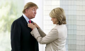 Stewart adjusts Trump’s tie during a photoshoot for The Apprentice.