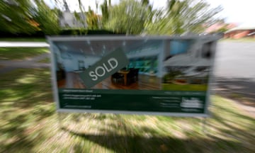 A real estate advertsing board with a Sold sign