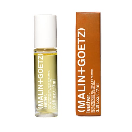 A bottle of fragrance. It is a clear bottle with white text and Malin and Goetz branding. It has a white lid. It is next to an ombre box packaging with white text. It is on a white background.