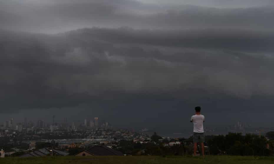 An onlooker at Dudley Page Reserve watches as a large thunderstorm moves over Sydney