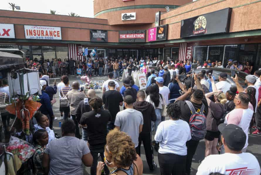 Fans of rapper Nipsey Hussle gather at a makeshift memorial in LA where Hussle was shot and killed the day before.