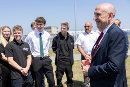 a man in a suit with people in the background