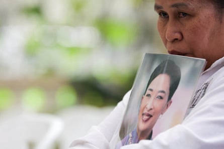 A woman crying as he holds a photo of the princess