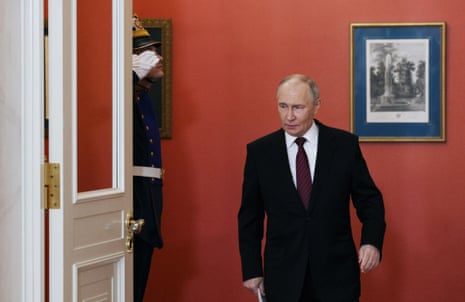 Vladimir Putin arrives to make a statement to the media at the Kremlin.
