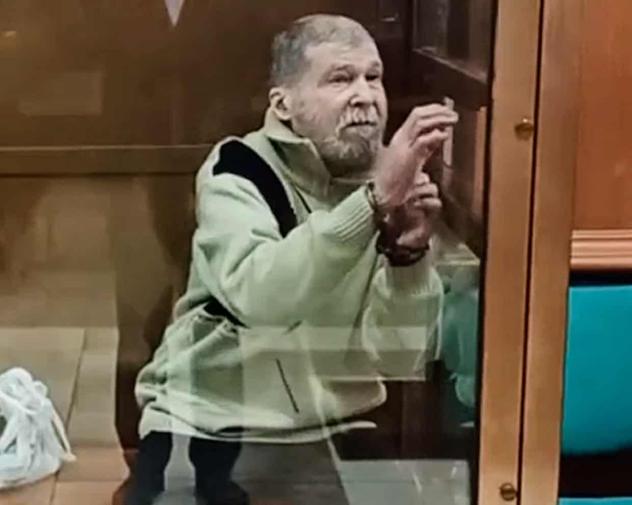 Stephen Hubbard behind a glass screen in court.