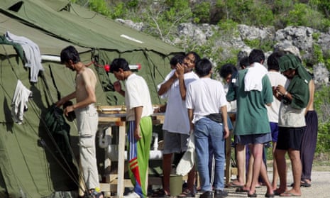 Men shave, brush their teeth and prepare for the day at a refugee camp on the island of Nauru