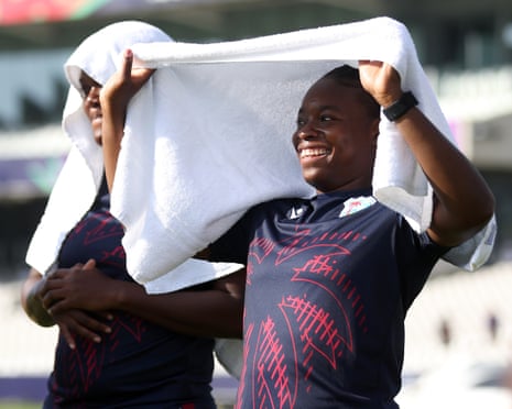 Aaliyah Alleyne of West Indies shelters under a towel during the warm-up.