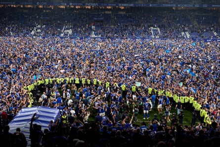Fans of Real Oviedo on the pitch celebrating their team’s promotion to La Liga