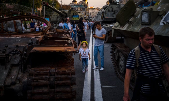 People look at destroyed Russian military equipment at Khreshchatyk street in Kyiv.