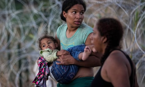 A woman carries her child after she and other migrants crossed the Rio Grande and entered the US. The image was part of a series by Associated Press photographers that won the 2024 Pulitzer prize for feature photography