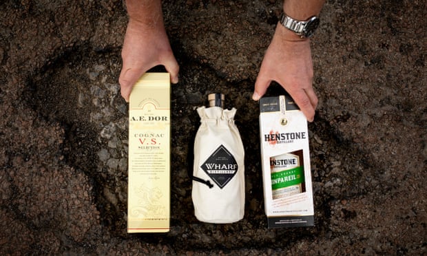 three bottles of brandy inside a pothole