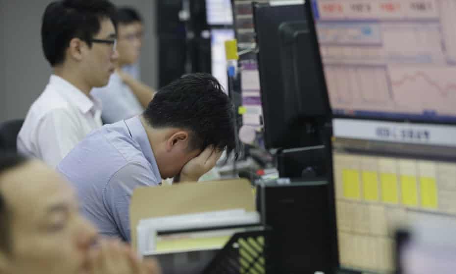 A currency trader at the foreign exchange dealing room of the Korea Exchange Bank headquarters in Seoul, South Korea