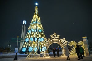 People take photographs of the new year decorations in the streets of Astana.