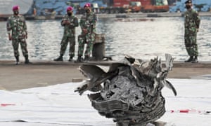 Indonesian marines look at a large part of a plane recovered from the waters off Java Island where Sriwijaya Air flight SJ-182 crashed on Saturday.