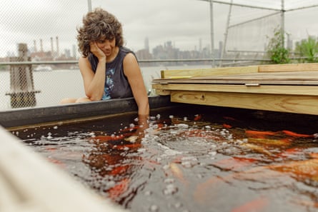 Becca Frank, an assistant professor at NYU, tends to fish in the aquaponics farm.