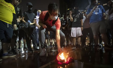 Demonstrators set light to a LeBron James jersey  during a rally