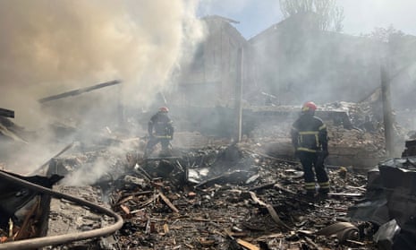 Firefighters work at the site of the missile strike in Kryvyi Rih