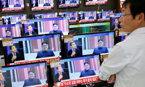 A sales assistant in Seoul watches TV sets broadcasting a news report on North Korea’s fifth nuclear test on Friday.