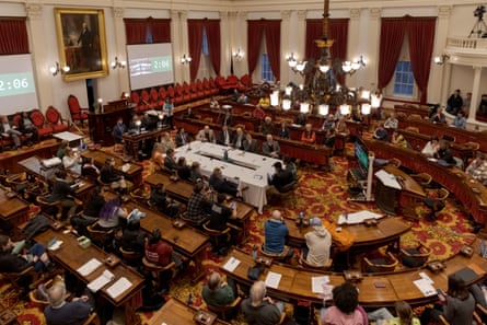 The interior of the Vermont state capitol, with legislators and audience